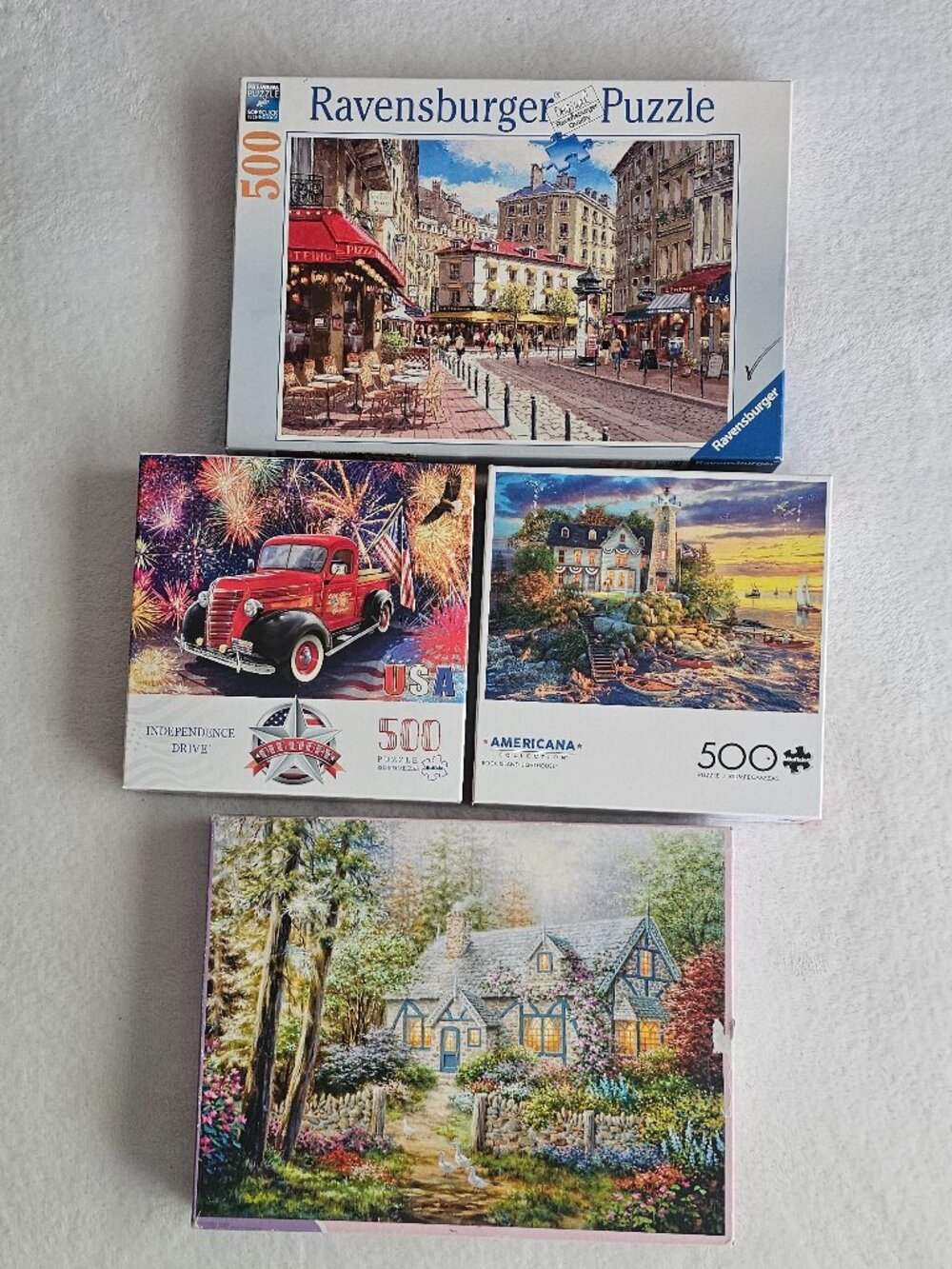 Collection of four jigsaw puzzles featuring various scenic and patriotic themes.